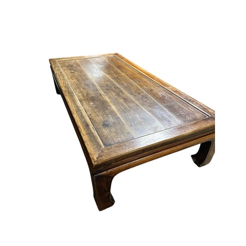 602 - A large low wooden coffee table in the oriental taste, 217cm long x 110c, wide x 54cm high, conditio... 