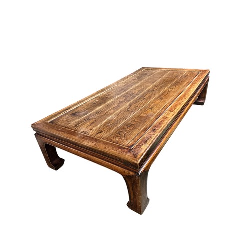 602 - A large low wooden coffee table in the oriental taste, 217cm long x 110c, wide x 54cm high, conditio... 