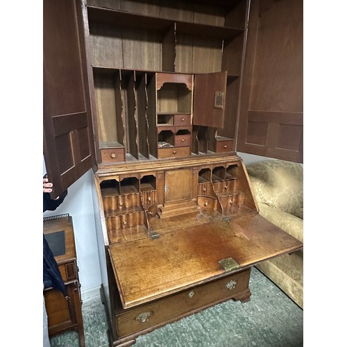 618 - A bureau book case, the top opening to reveal a fitted stationery interior, with brass drop handles,... 