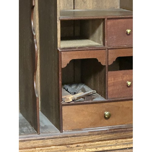 618 - A bureau book case, the top opening to reveal a fitted stationery interior, with brass drop handles,... 