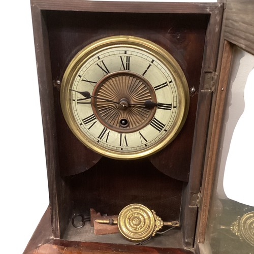 404 - A mahogany mantle clock with broken arch pediment, and brass mounts and a brass circular dial with b... 