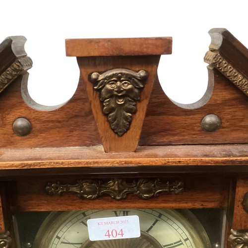 404 - A mahogany mantle clock with broken arch pediment, and brass mounts and a brass circular dial with b... 