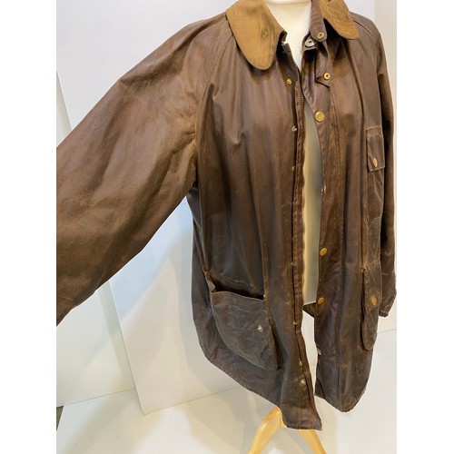 217 - BARBOUR coat. Worn with some ware marks, with belt, hole in lining. Inside armpit to armpit 65cm, le... 