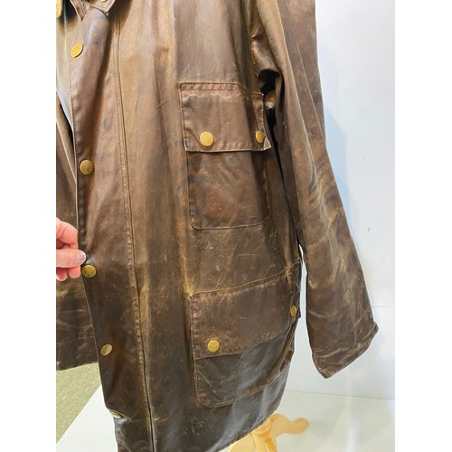 217 - BARBOUR coat. Worn with some ware marks, with belt, hole in lining. Inside armpit to armpit 65cm, le... 