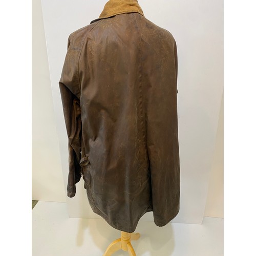 217 - BARBOUR coat. Worn with some ware marks, with belt, hole in lining. Inside armpit to armpit 65cm, le... 