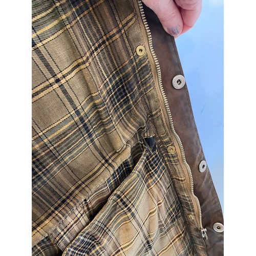 217 - BARBOUR coat. Worn with some ware marks, with belt, hole in lining. Inside armpit to armpit 65cm, le... 