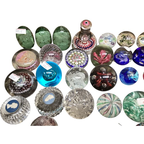 435 - A large collection of glass paperweights, including Caithness,  Perthshire, etc.