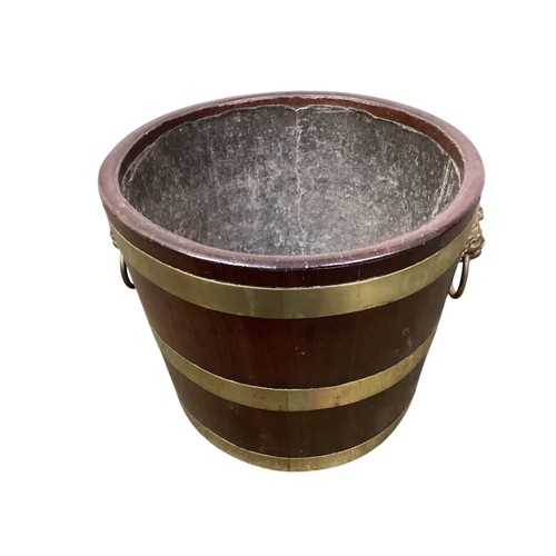 408 - An Irish brass bound mahogany peat bucket, with lion mask handles.