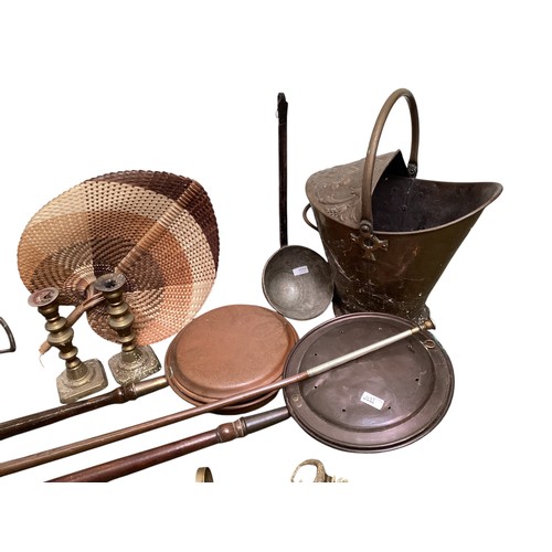 443 - A quantity of brass and copper wares to include bed warming pans, coalscuttle, brass candlesticks, c... 