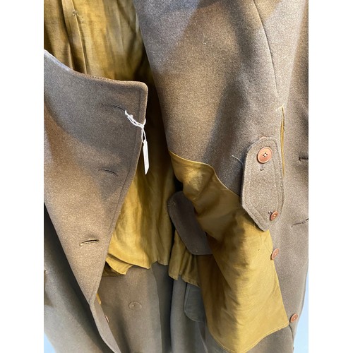 220 - Two wool army style overcoats. Green with double breasted brass style buttons, some damage/repairs a... 