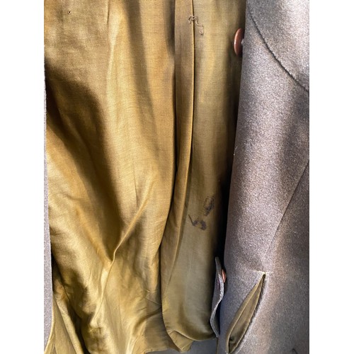 220 - Two wool army style overcoats. Green with double breasted brass style buttons, some damage/repairs a... 