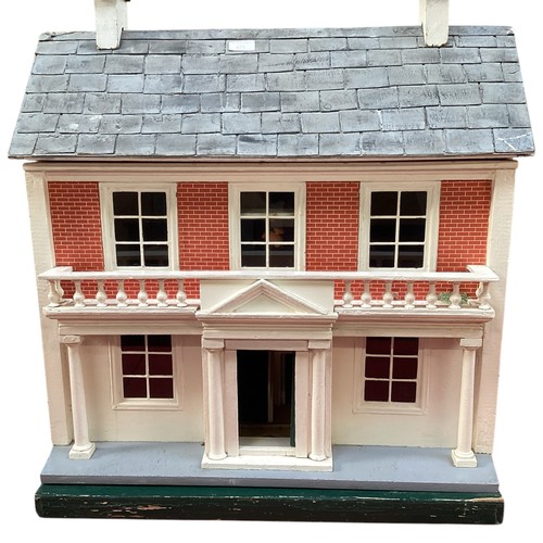 471 - A wooden dolls house, height including chimneys, 72cm, 35cm depth, 65cm wide.