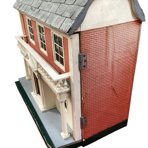 471 - A wooden dolls house, height including chimneys, 72cm, 35cm depth, 65cm wide.