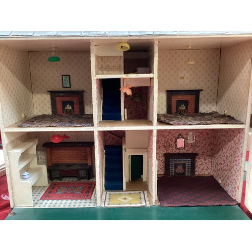 471 - A wooden dolls house, height including chimneys, 72cm, 35cm depth, 65cm wide.