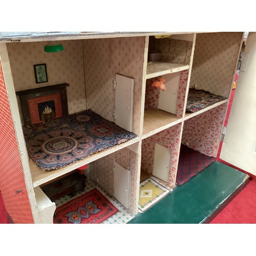 471 - A wooden dolls house, height including chimneys, 72cm, 35cm depth, 65cm wide.