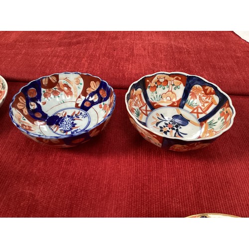 458 - A quantity of Japanese Imari to include a large charger 40cm diameter, and a pair of scalloped dishe... 