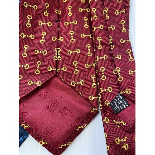 234 - Three Gucci silk ties. Red back ground with tradition horse bit gold pattern, blue back ground with ... 