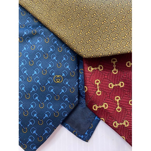 234 - Three Gucci silk ties. Red back ground with tradition horse bit gold pattern, blue back ground with ... 