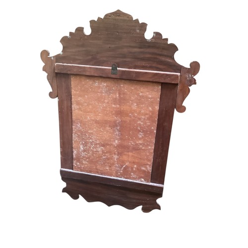 508 - A wall mirror with carved copper  decorative frame, 90cm high x 56cm wide including frame