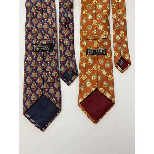 236 - Four Gucci silk ties.  Navy background with tassel and bow pattern, green background with moon face ... 