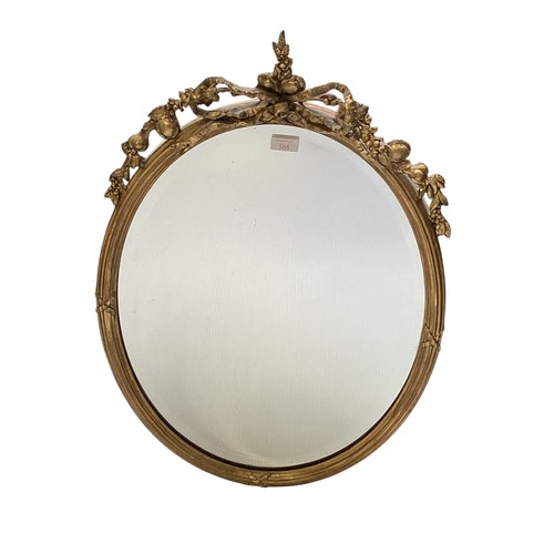 505 - Two mirrors: An oval gilt frame wall mirror, with fruit and foliage final to top, 76cm high overall ... 