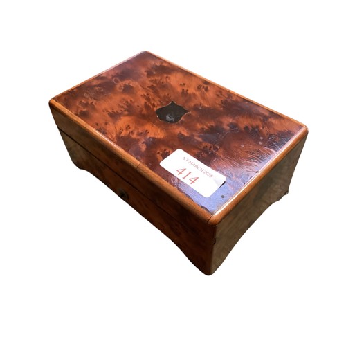 414 - A small sized Burr walnut Swiss music box with 12 Aires, much wear.