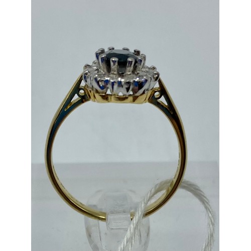 276 - An 18ct gold sapphire and diamond ring, central oval free cut sapphire, with a surround of 10 single... 