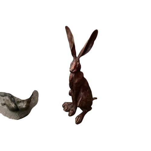 486 - A collection of bronze and composite resin models of animals.Otter, rabbits and hares.