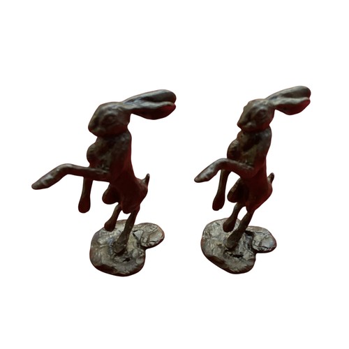 486 - A collection of bronze and composite resin models of animals.Otter, rabbits and hares.