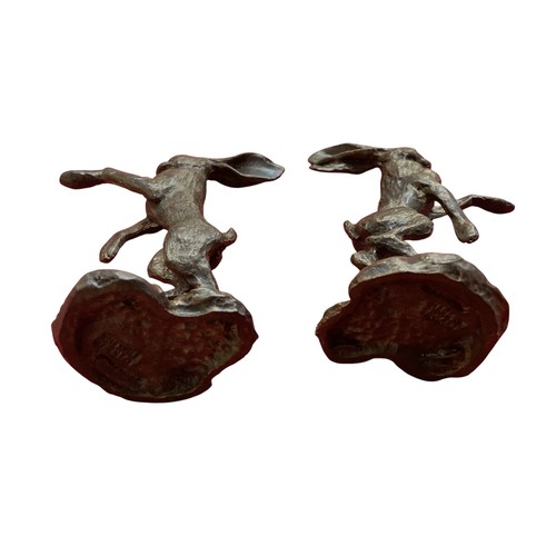 486 - A collection of bronze and composite resin models of animals.Otter, rabbits and hares.