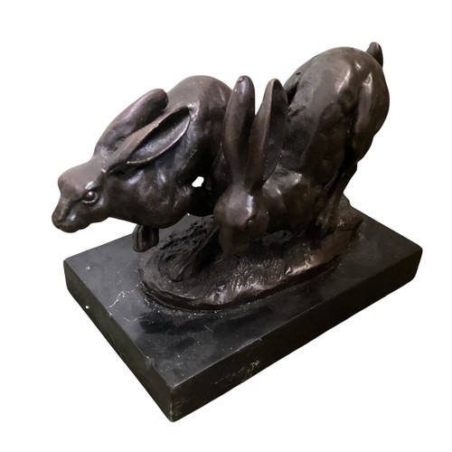 486 - A collection of bronze and composite resin models of animals.Otter, rabbits and hares.