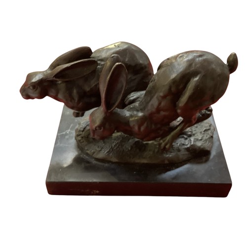 486 - A collection of bronze and composite resin models of animals.Otter, rabbits and hares.