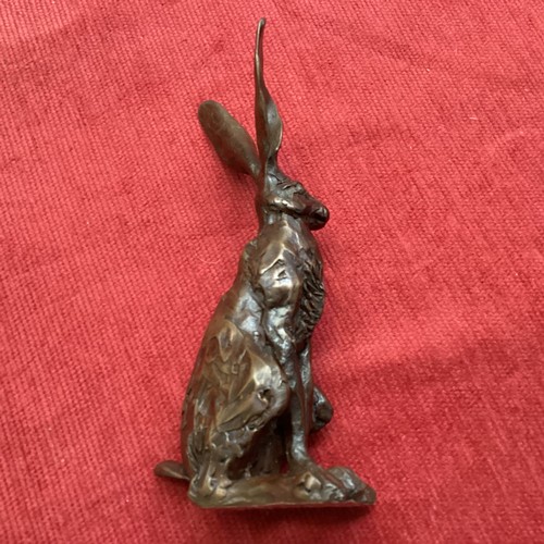 486 - A collection of bronze and composite resin models of animals.Otter, rabbits and hares.