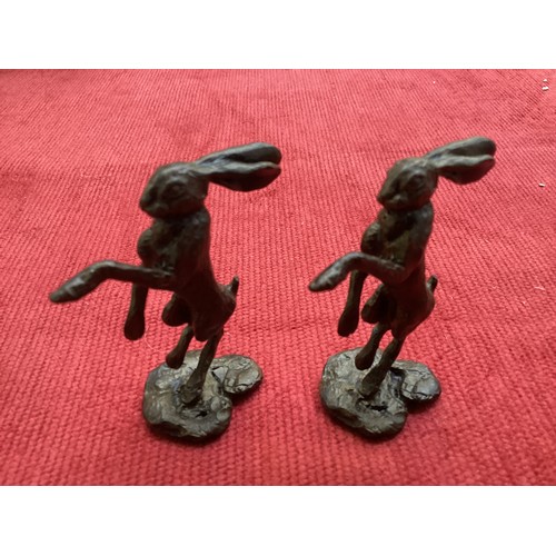 486 - A collection of bronze and composite resin models of animals.Otter, rabbits and hares.