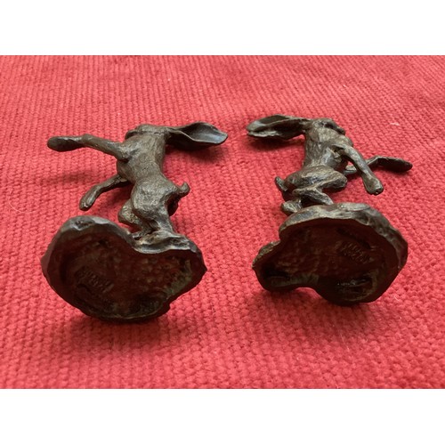 486 - A collection of bronze and composite resin models of animals.Otter, rabbits and hares.