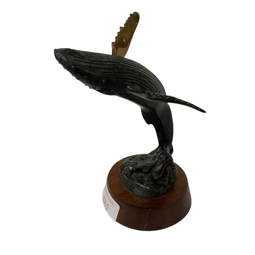 485 - A bronze, Verdigris model of a blue whale, signed and dated Randy Puckett 1992 on wooden base. 14cm(... 