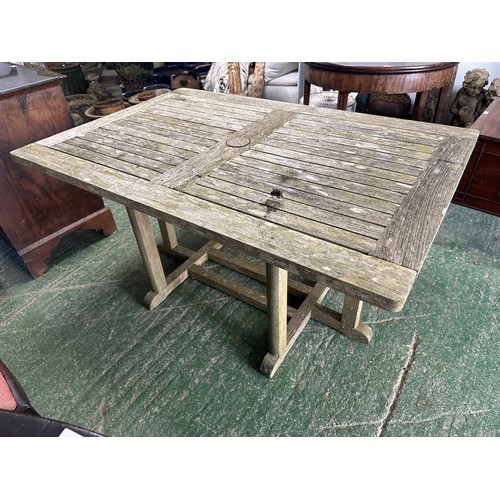 652 - A weathered teak garden table and four chairs