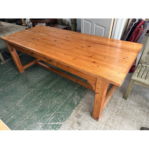 653 - A pine kitchen table, with 4 square legs and united with H stretcher to base, as found with some wea... 