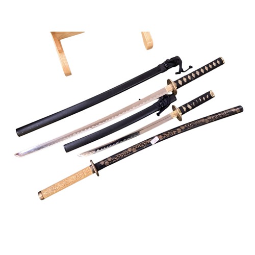 496 - Two samurai style swords on stand with one other.