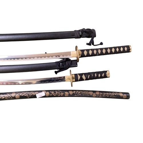 496 - Two samurai style swords on stand with one other.