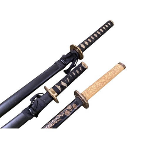 496 - Two samurai style swords on stand with one other.