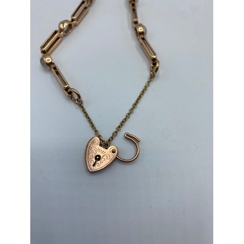 279 - A 9ct rose gold bracelet set with 6 cabochon moonstones with 9ct gold heart locket, 15.5g