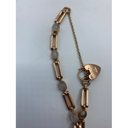 279 - A 9ct rose gold bracelet set with 6 cabochon moonstones with 9ct gold heart locket, 15.5g