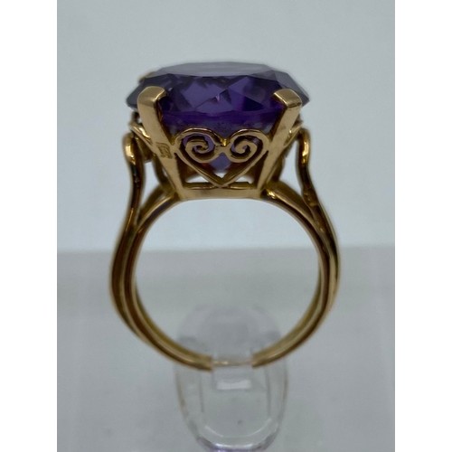 309 - A large yellow metal Amethyst dress ring. Hallmarks worn possibly 14ct gold. Size H. 5.9g