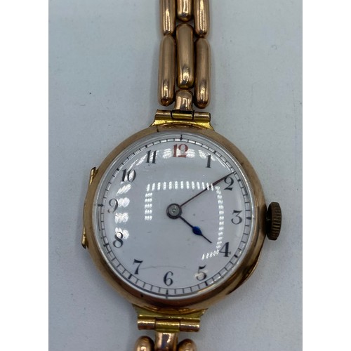 325 - A Gents, 9ct gold chain link wrist watch, with circular white dial and black and red numerals. On a ... 