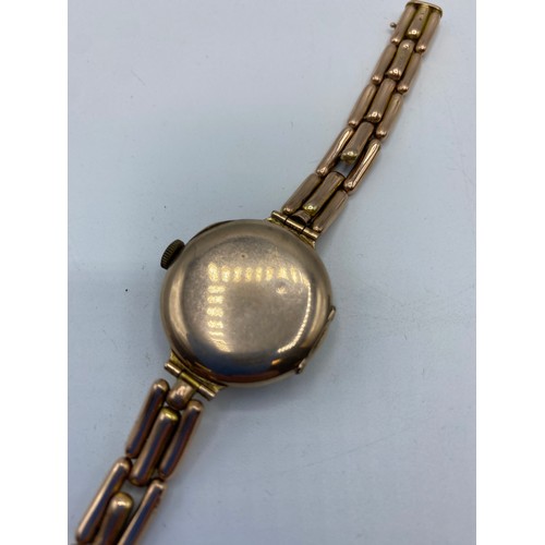 325 - A Gents, 9ct gold chain link wrist watch, with circular white dial and black and red numerals. On a ... 