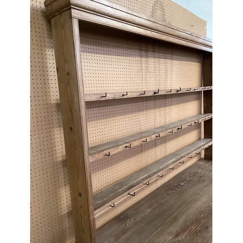 649 - A rustic pine pine kitchen dresser with 8 drawers and cupboard to base below a plate rack