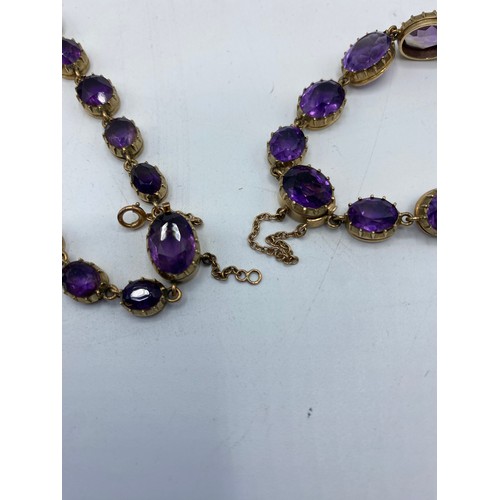 308 - A 9ct gold and oval cut graduated amethyst. Late 19th early 20th Century amethyst suite of jewellery... 