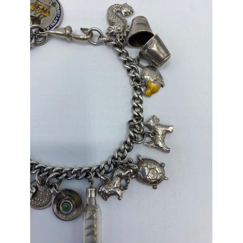 269 - A sterling silver charm bracelet set with numerous sterling silver charms, 50g