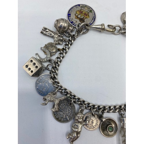 269 - A sterling silver charm bracelet set with numerous sterling silver charms, 50g